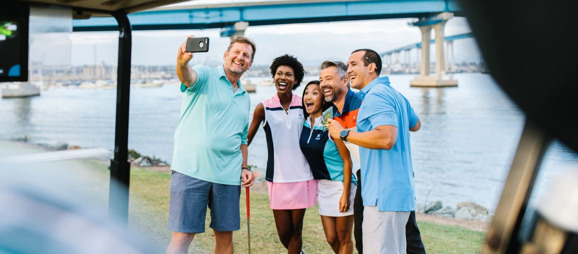 group of friends playing golf and smiling for a selfie at coronado golf course